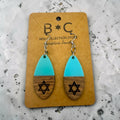 Holy Land Mall teardrop earrings with turquoise acrylic tops and laser-engraved wooden Star of David bases.