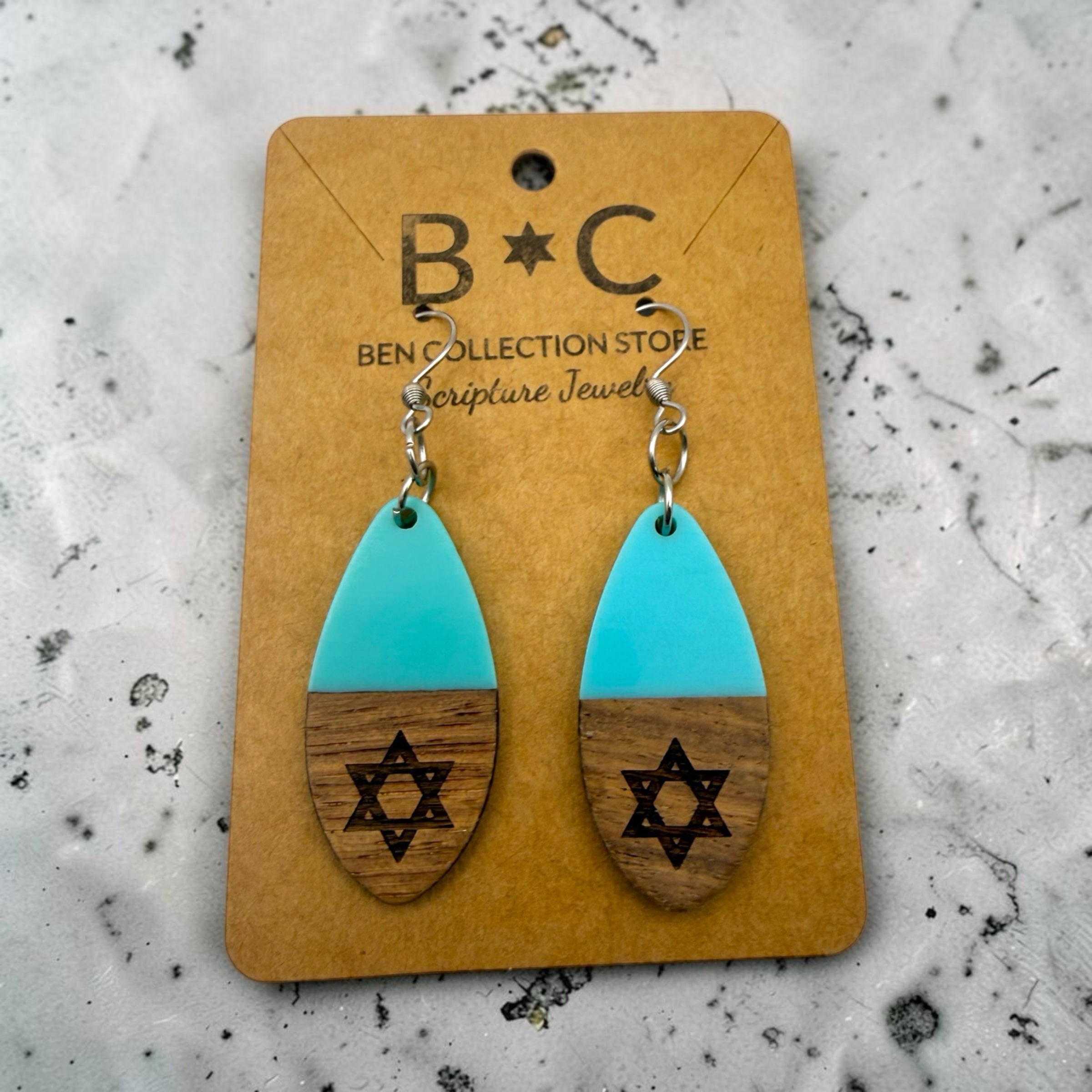Holy Land Mall teardrop earrings with turquoise acrylic tops and laser-engraved wooden Star of David bases.