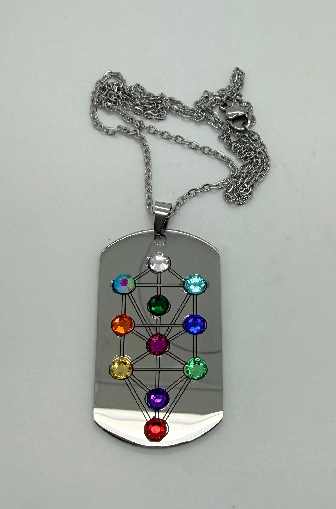 Holy Land Mall stainless steel dog tag pendant featuring an etched Tree of Life motif with colorful chakra crystals.